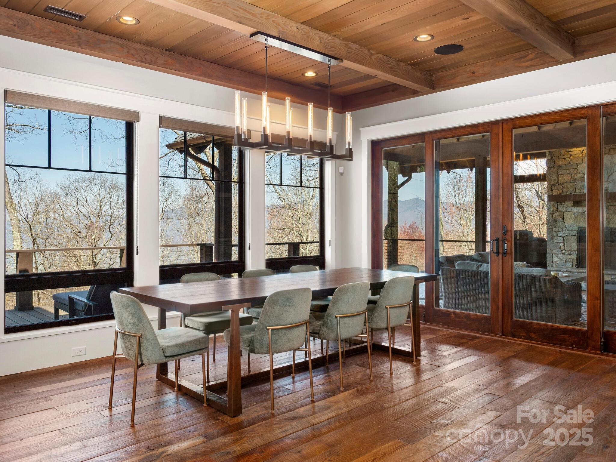 61 Back Bone Way, Unit 203 Sylva, NC 28779 - Photo 11 of 48 a dining room with wooden floor and large windows