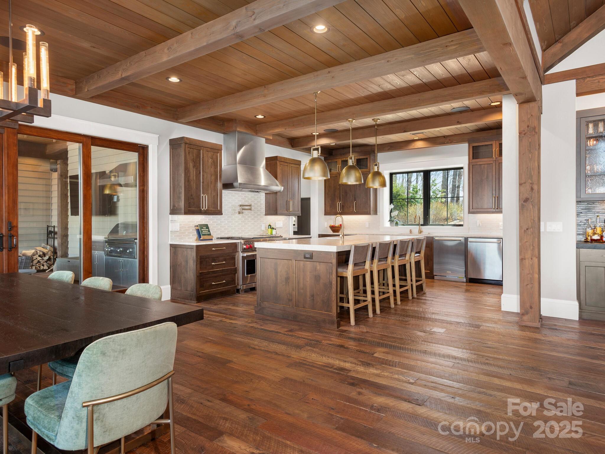 61 Back Bone Way, Unit 203 Sylva, NC 28779 - Photo 12 of 48 a dining hall with stainless steel appliances kitchen island granite countertop a table chairs and a view of living room
