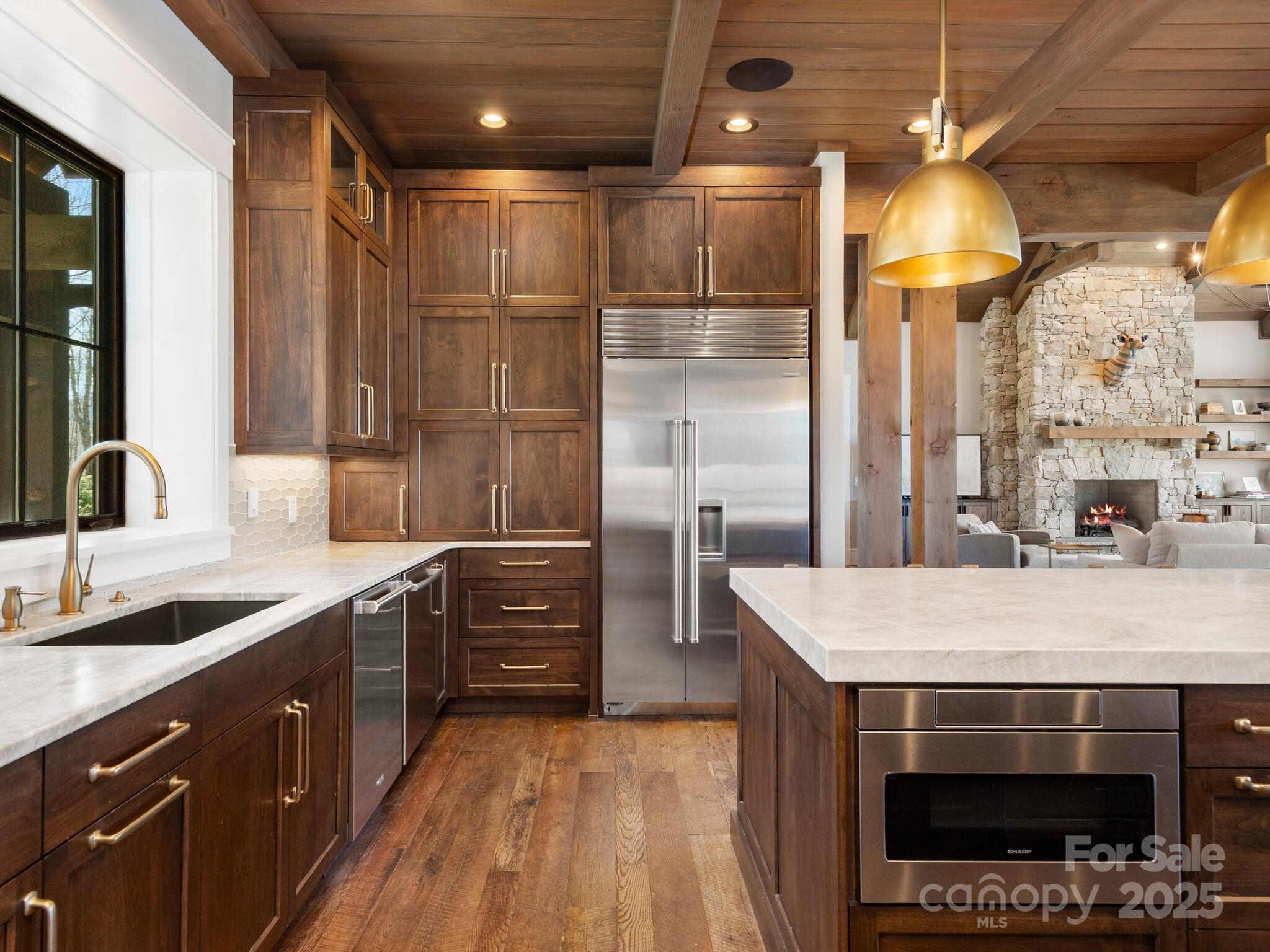 61 Back Bone Way, Unit 203 Sylva, NC 28779 - Photo 16 of 48 a kitchen with stainless steel appliances a stove a refrigerator and cabinets