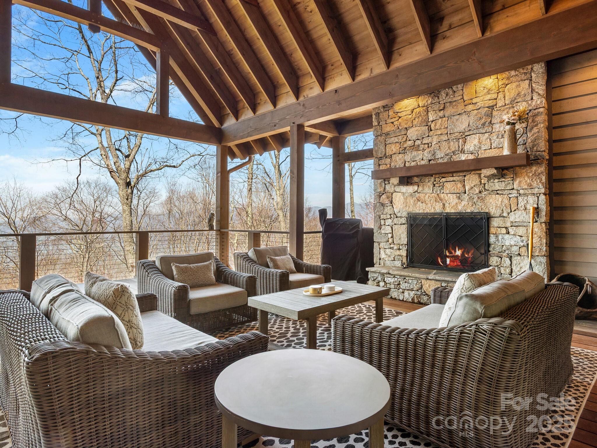 61 Back Bone Way, Unit 203 Sylva, NC 28779 - Photo 17 of 48 a living room with furniture a fireplace and a floor to ceiling window