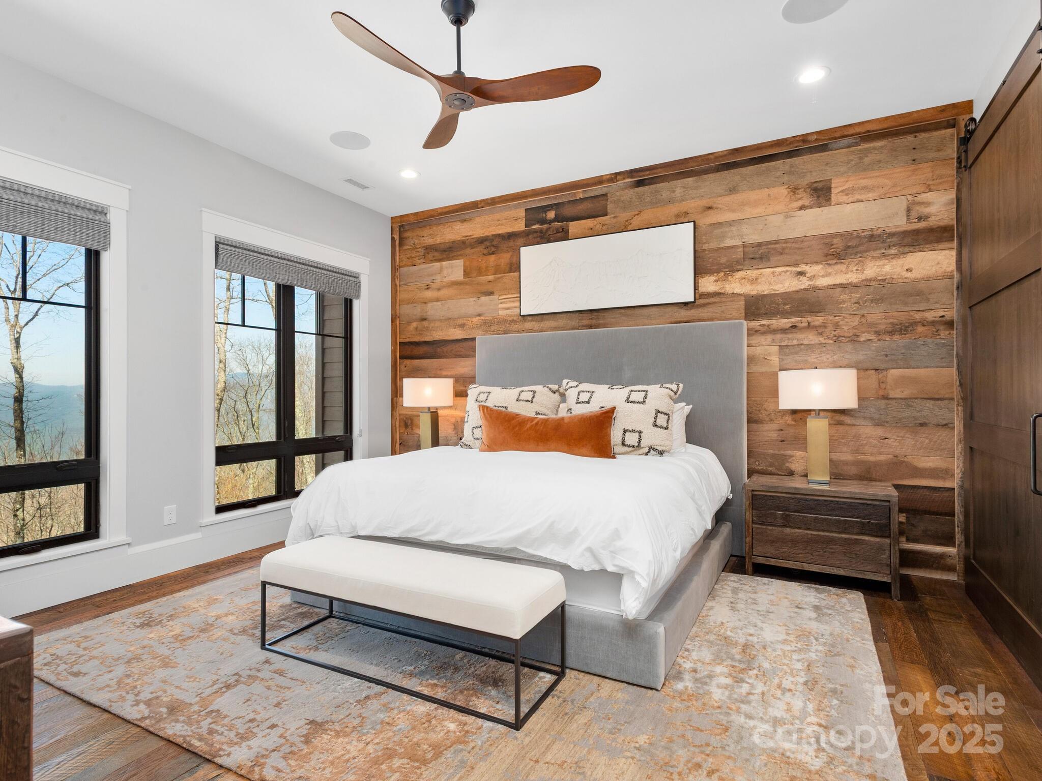 61 Back Bone Way, Unit 203 Sylva, NC 28779 - Photo 19 of 48 a bedroom with a bed and large window