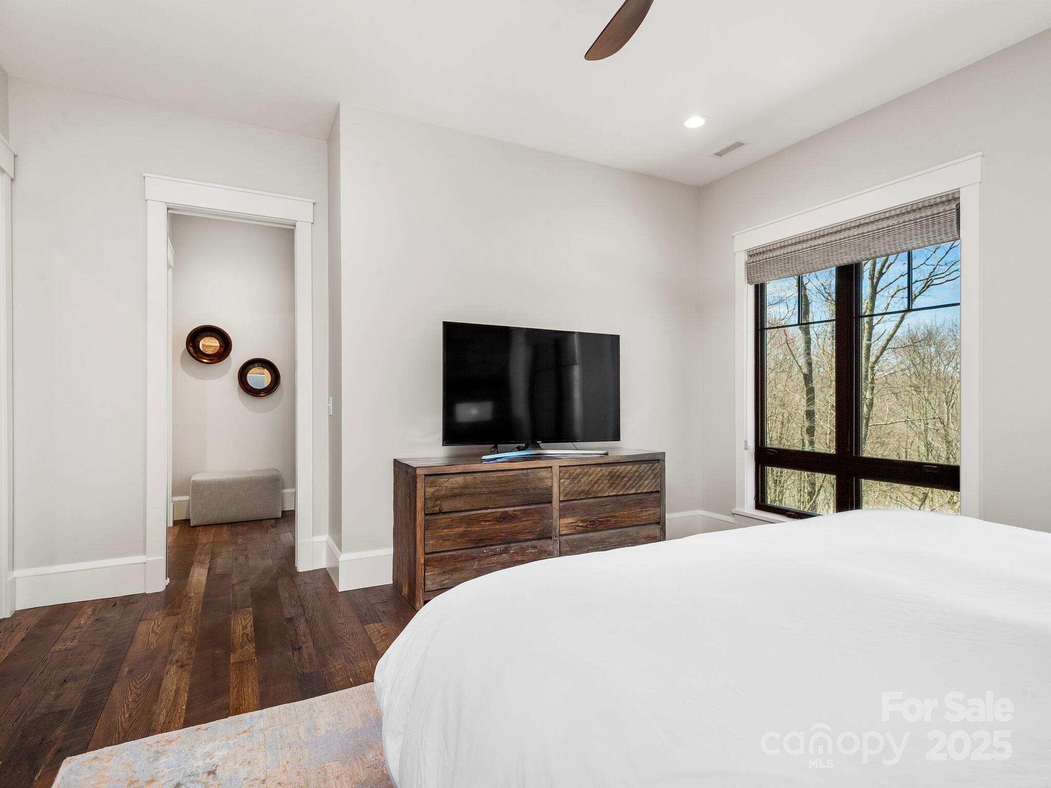 61 Back Bone Way, Unit 203 Sylva, NC 28779 - Photo 20 of 48 a bedroom with a bed and a flat screen tv