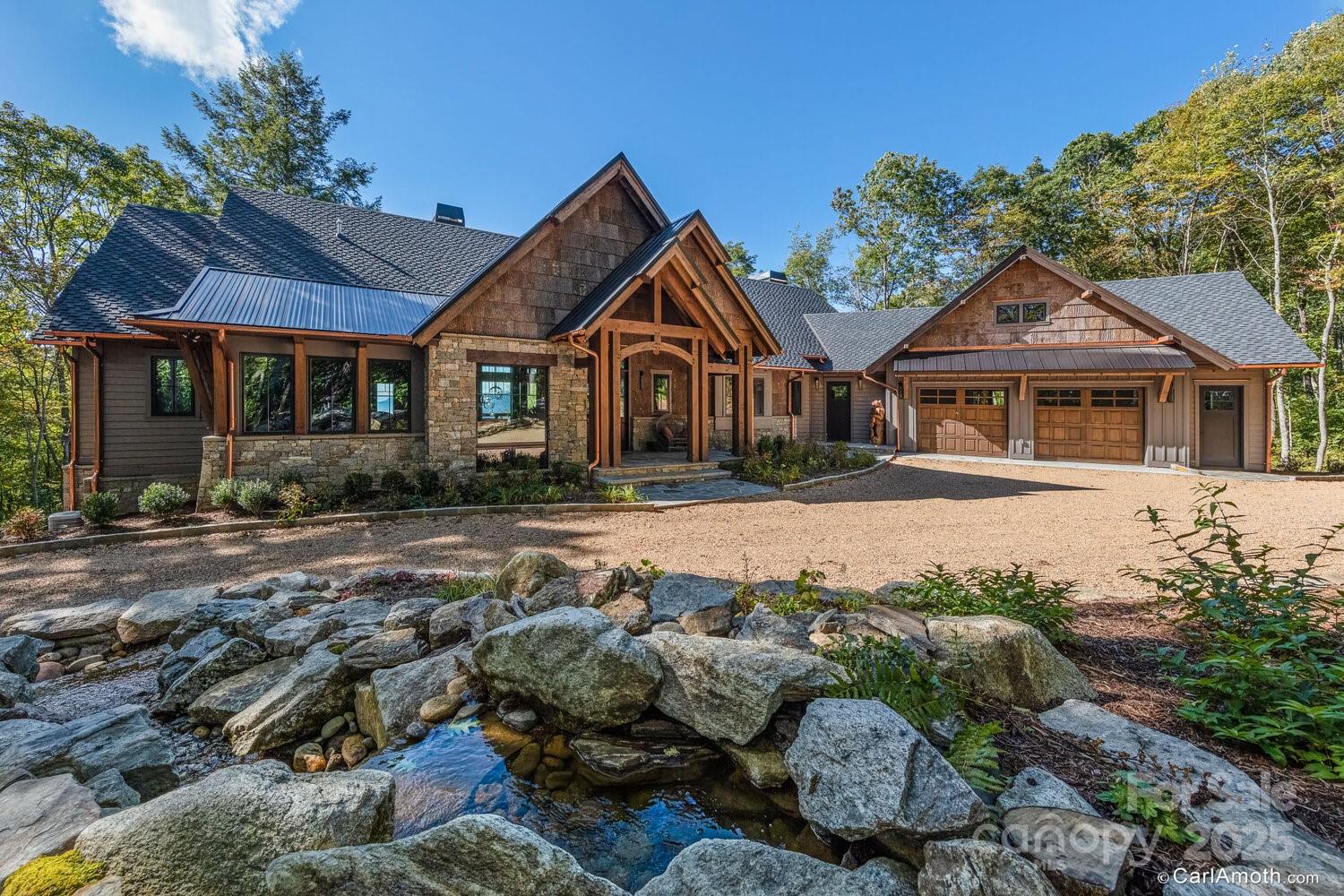 61 Back Bone Way, Unit 203 Sylva, NC 28779 - Photo 2 of 48 a front view of a house with a yard and potted plants