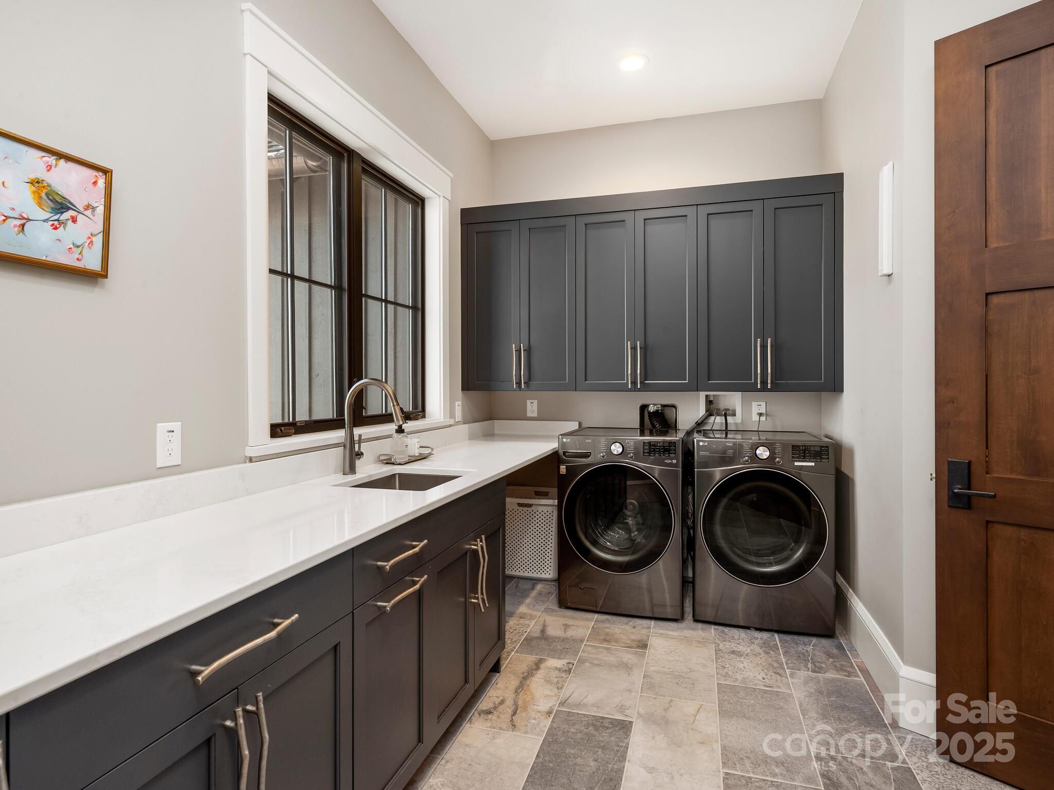 61 Back Bone Way, Unit 203 Sylva, NC 28779 - Photo 26 of 48 a utility room with a sink a washer and dryer