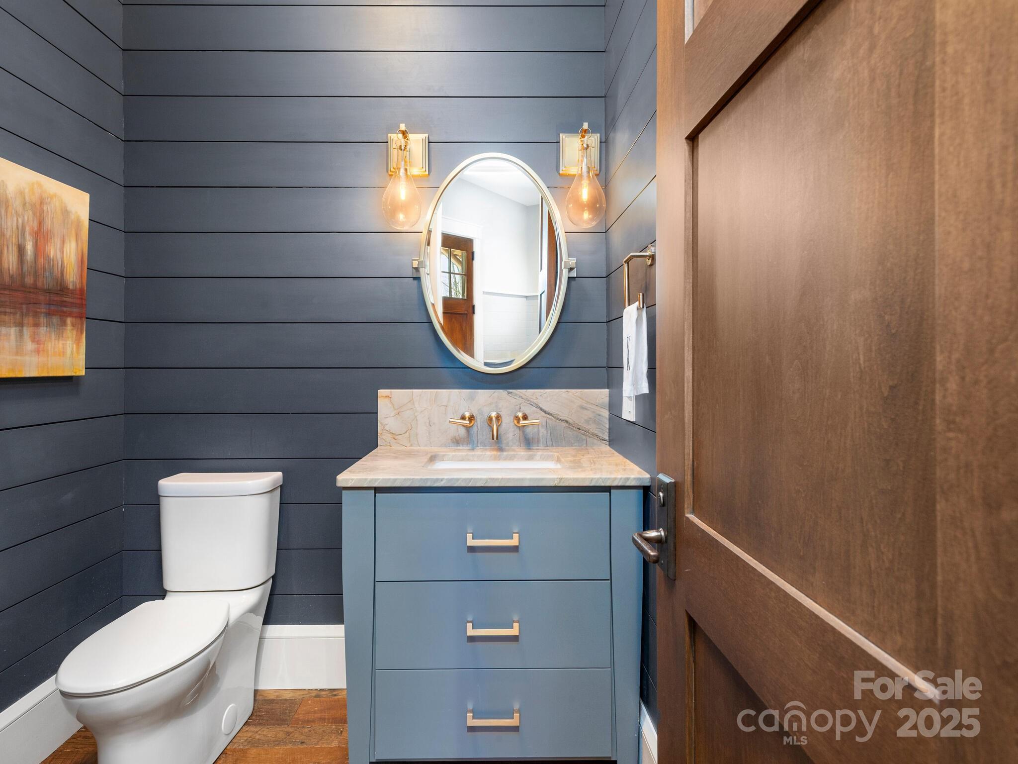 61 Back Bone Way, Unit 203 Sylva, NC 28779 - Photo 28 of 48 a bathroom with a toilet a sink and mirror