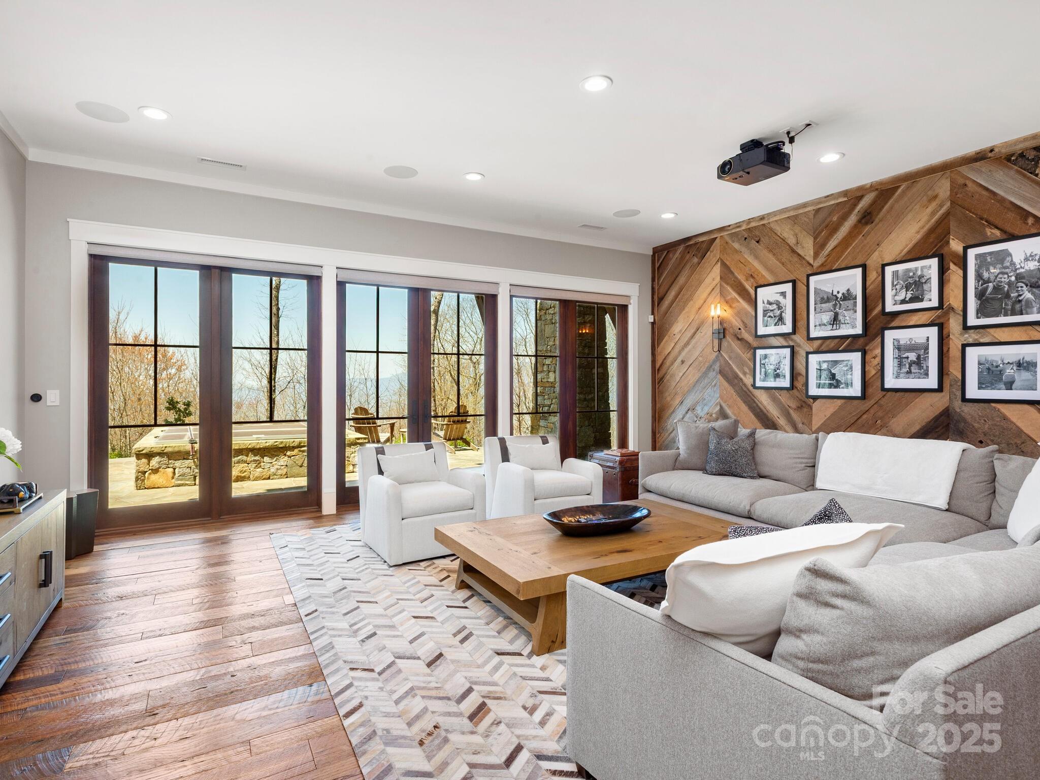 61 Back Bone Way, Unit 203 Sylva, NC 28779 - Photo 30 of 48 a living room with furniture and large windows