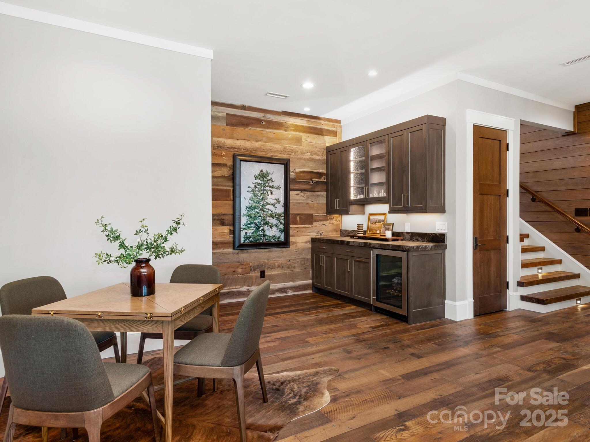 61 Back Bone Way, Unit 203 Sylva, NC 28779 - Photo 33 of 48 a kitchen with stainless steel appliances kitchen island granite countertop a table chairs and a refrigerator