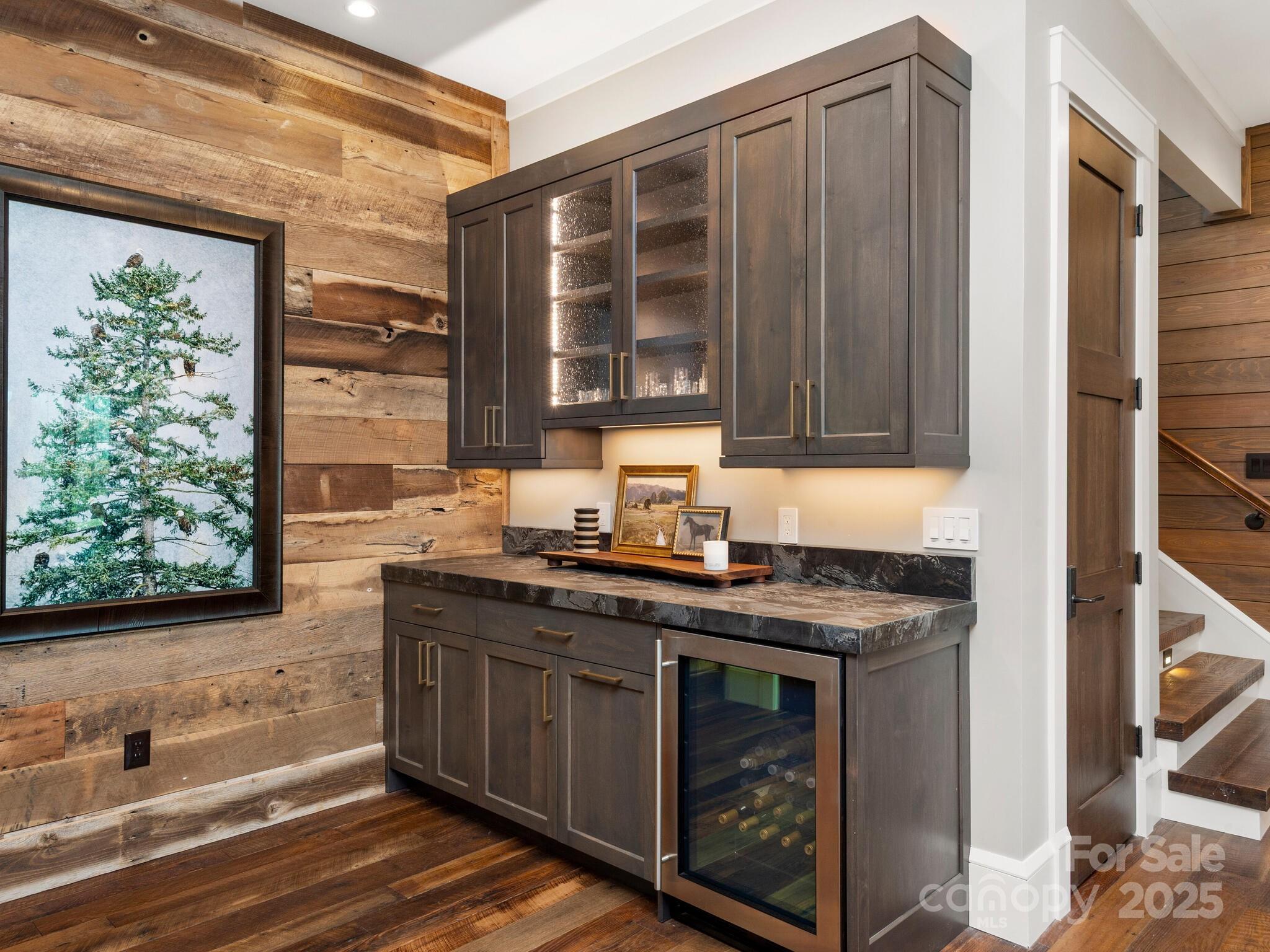 61 Back Bone Way, Unit 203 Sylva, NC 28779 - Photo 34 of 48 a kitchen with stainless steel appliances granite countertop a sink a stove and a wooden cabinets