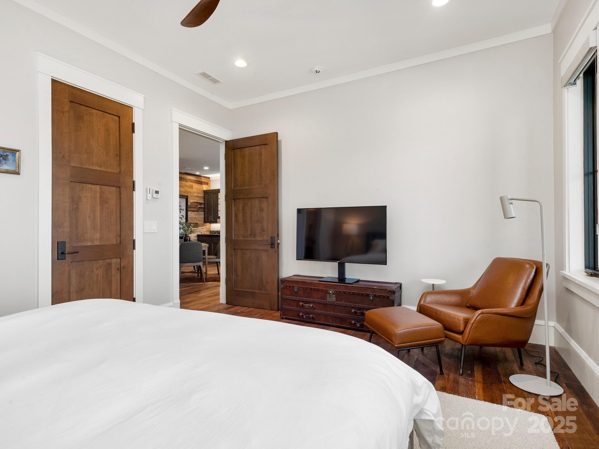 61 Back Bone Way, Unit 203 Sylva, NC 28779 - Photo 36 of 48 a bedroom with a bed and a chair