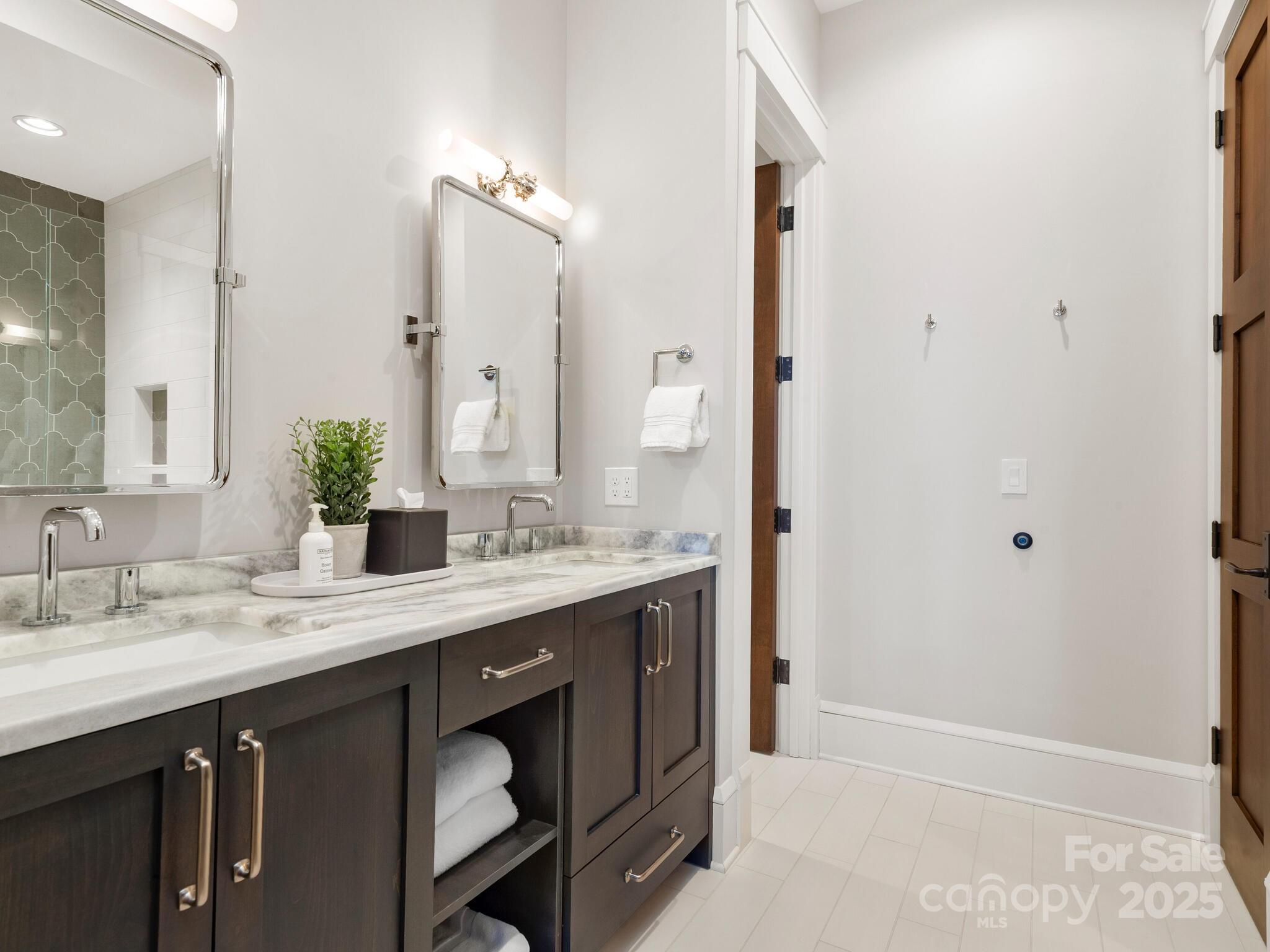 61 Back Bone Way, Unit 203 Sylva, NC 28779 - Photo 37 of 48 a bathroom with a granite countertop sink and a mirror