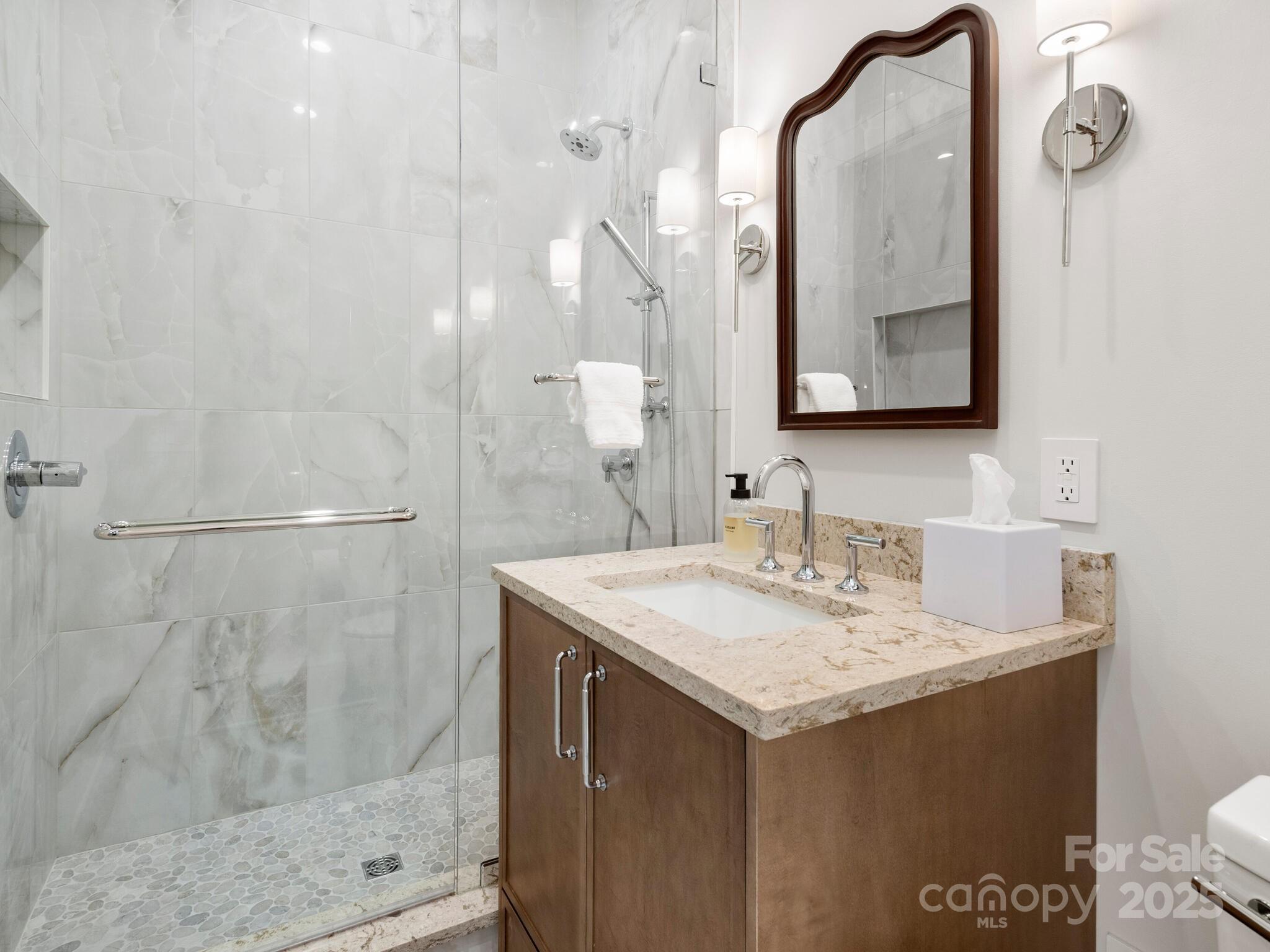 61 Back Bone Way, Unit 203 Sylva, NC 28779 - Photo 45 of 48 a bathroom with a sink vanity granite and a mirror