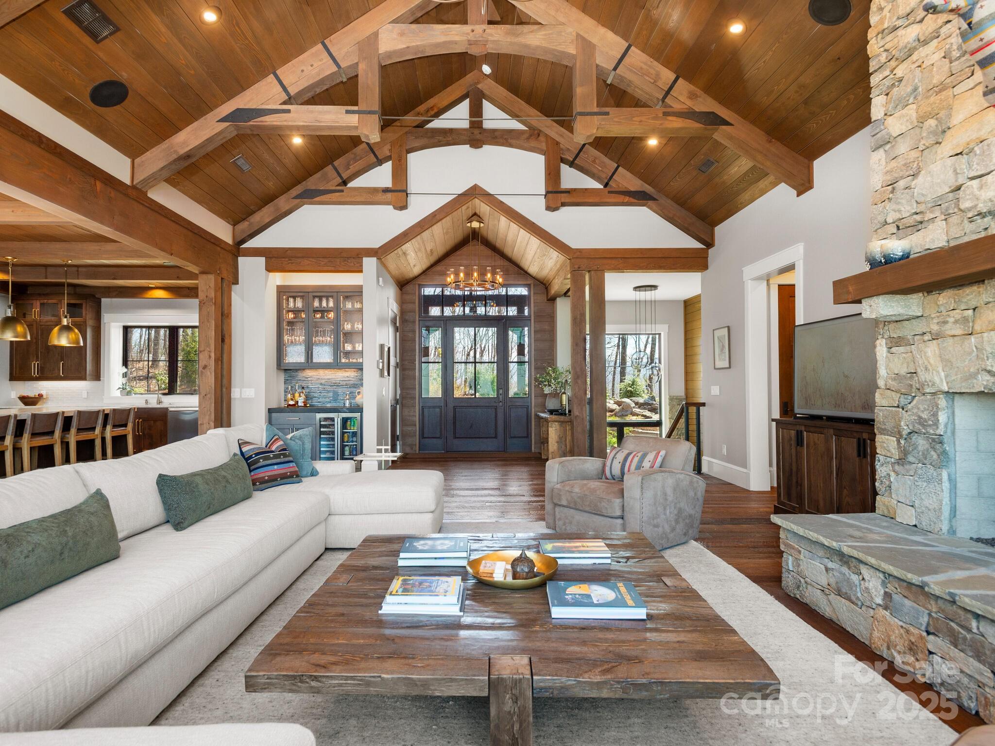 61 Back Bone Way, Unit 203 Sylva, NC 28779 - Photo 9 of 48 a living room with furniture and a chandelier