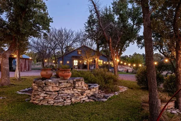a backyard of a house with table and chairs