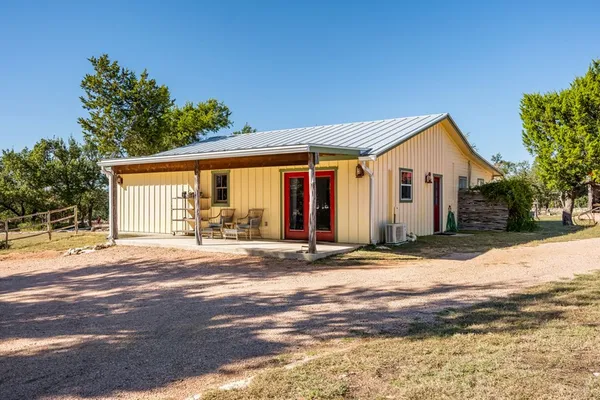 a living room with furniture and wooden floors