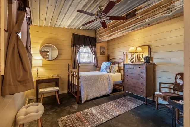 a large white kitchen with stainless steel appliances granite countertop a stove a sink dishwasher and white cabinets with wooden floor