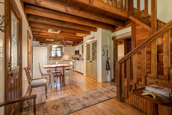 a view of a house with a yard and tree