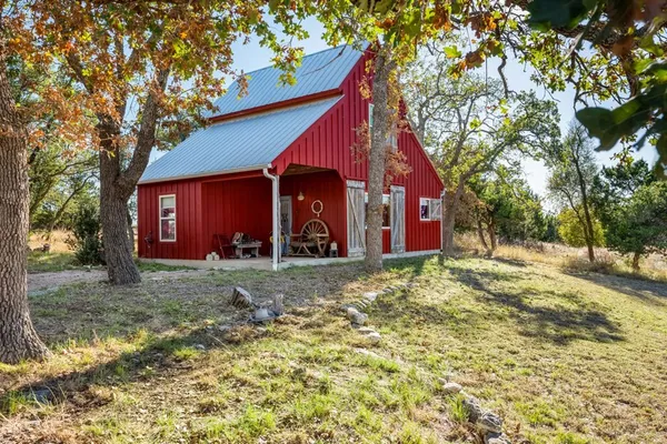 a view of a house with swimming pool and sitting area
