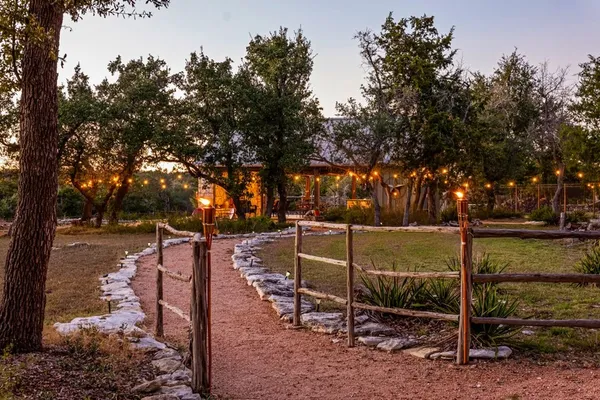 a view of a house with swimming pool and sitting area