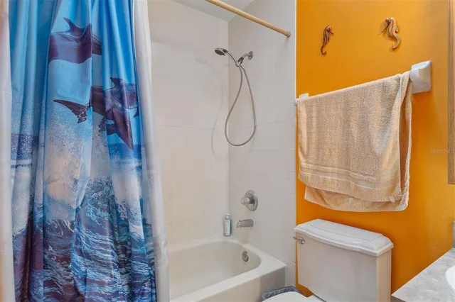 a bathroom with a shower and a toilet