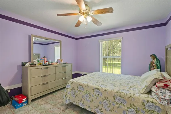 a bedroom with a bed and a mirror on dresser