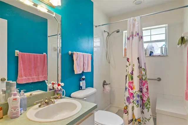 a bathroom with a sink toilet and shower