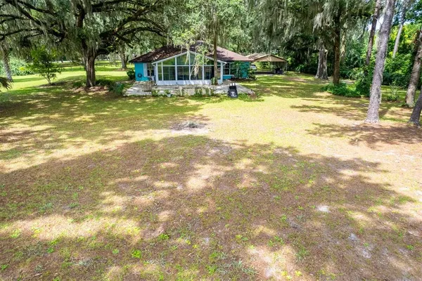 a front view of a house with a yard table and chairs