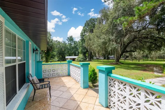 a view of a chair and tables in the balcony