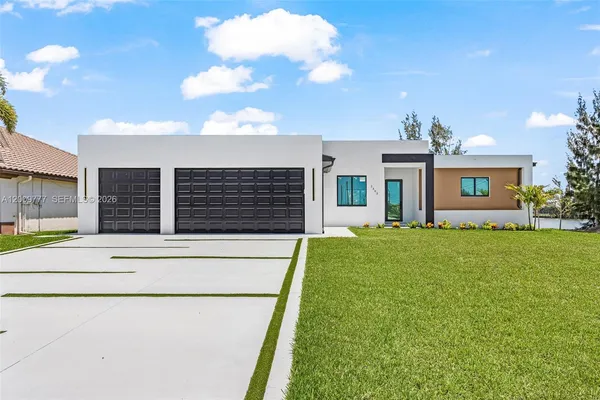 a front view of a house with a garden