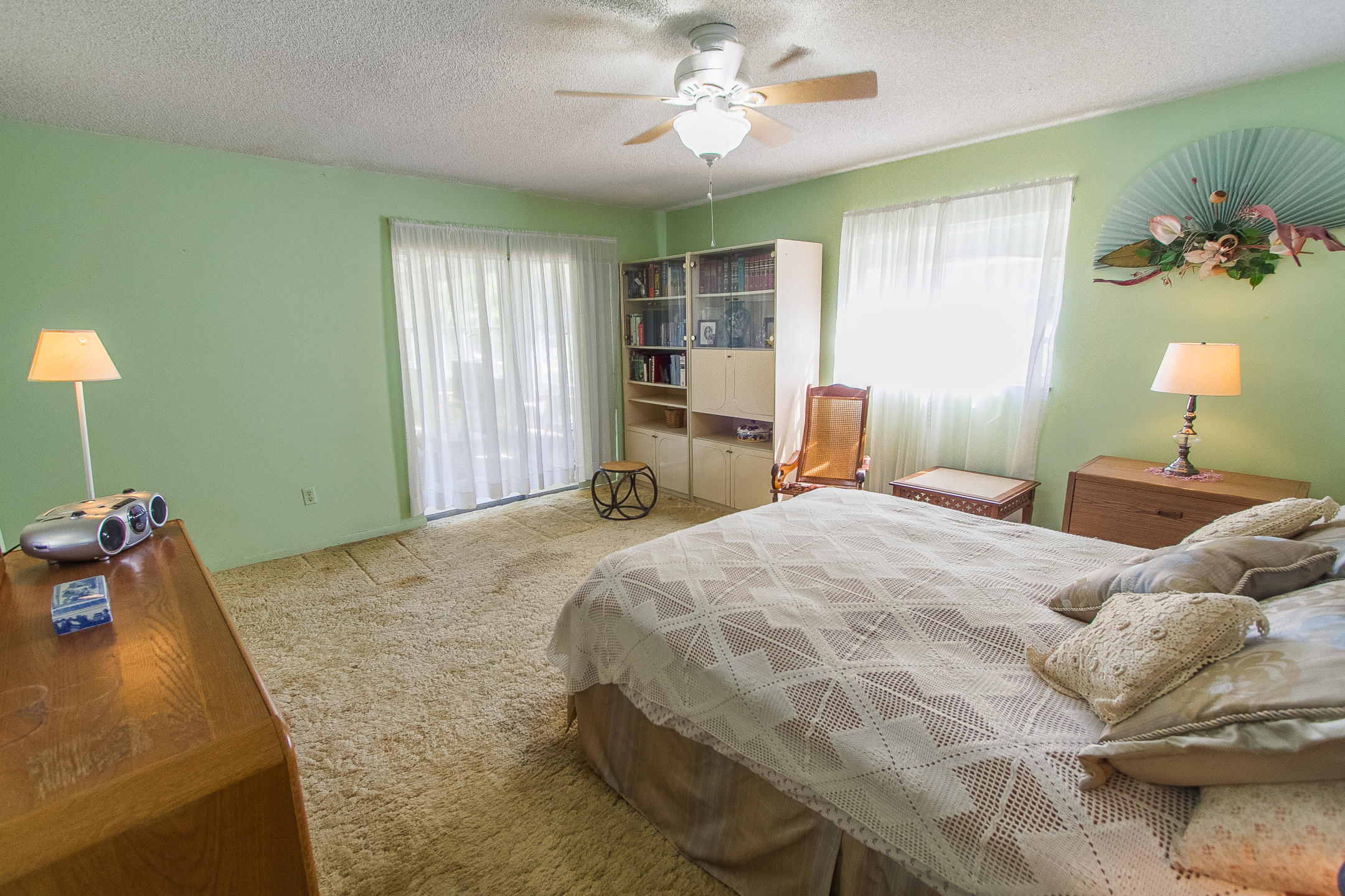 22366 Southwest 65th Avenue Boca Raton, FL 33428 - Photo 18 of 22 a bedroom with a bed and a chandelier