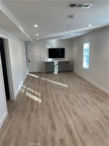 a view of a livingroom with an empty space and a window