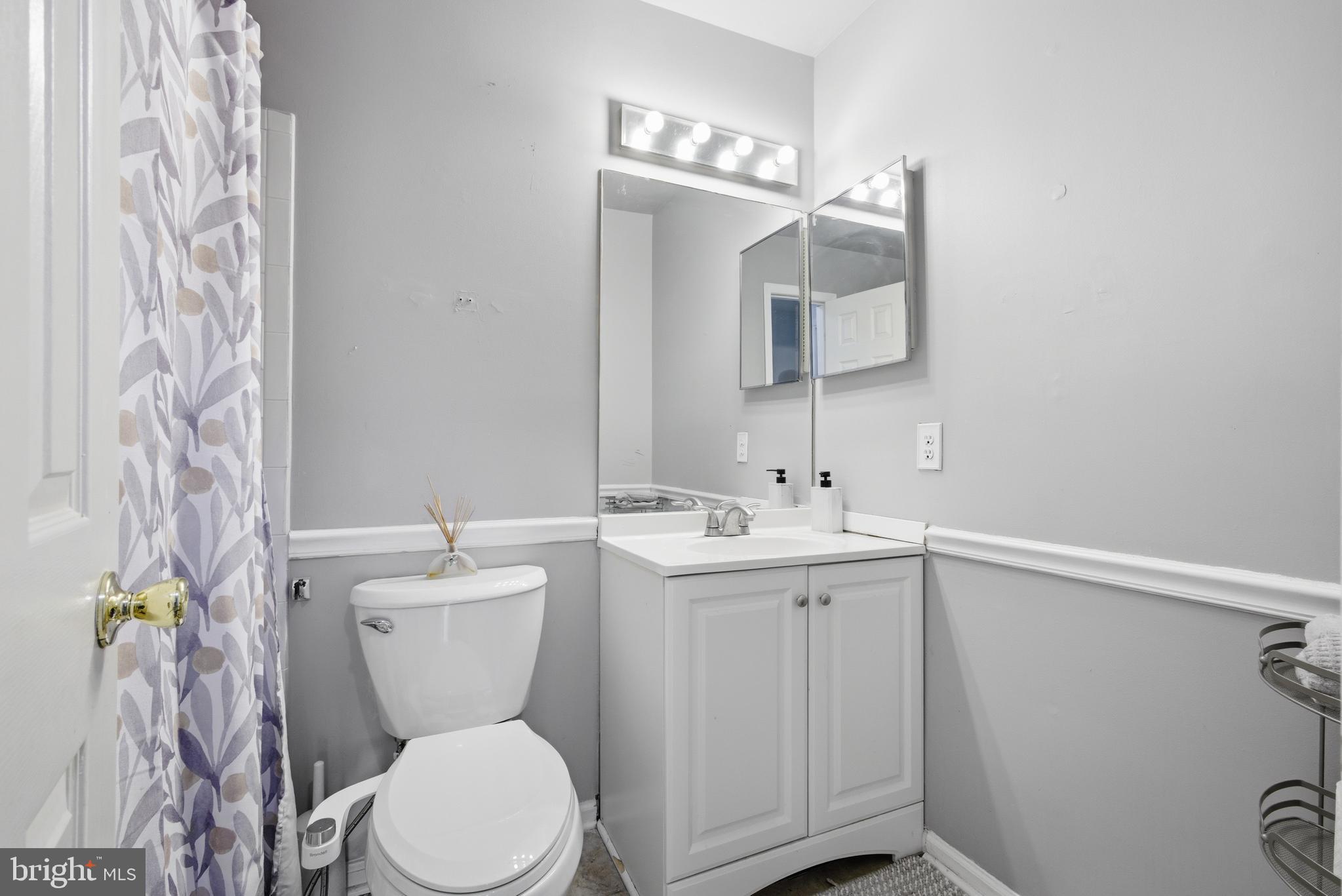 8664 Pohick Forest Court Springfield, VA 22153 - Photo 33 of 41 a bathroom with a toilet sink and mirror