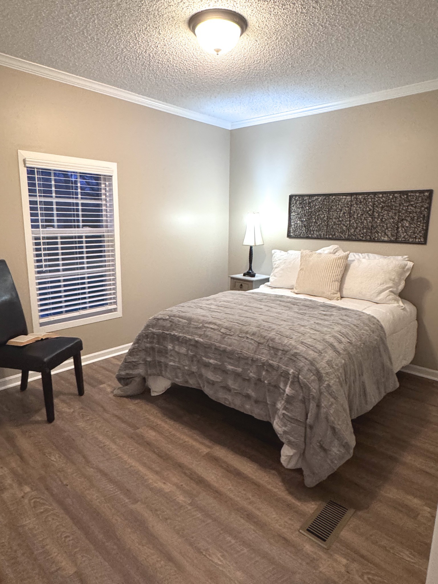 181 Duke Road Dickson, TN 37055 - Photo 12 of 22 a bedroom with a bed and wooden floor