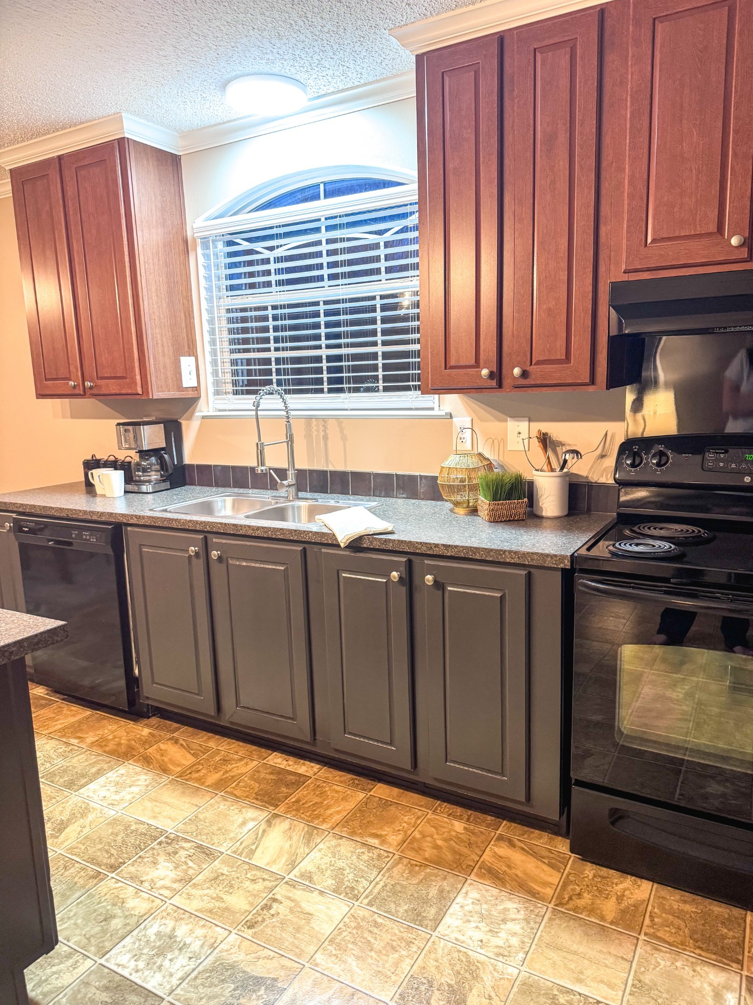 181 Duke Road Dickson, TN 37055 - Photo 3 of 22 a kitchen with stainless steel appliances granite countertop wooden cabinets a stove a sink and a window