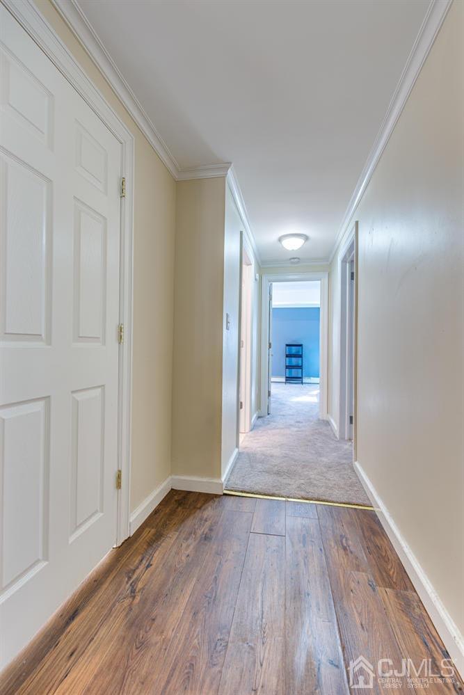1337 Lower Ferry Road Ewing, NJ 08618 - Photo 22 of 40 a view of a hallway with wooden floor and a bathroom