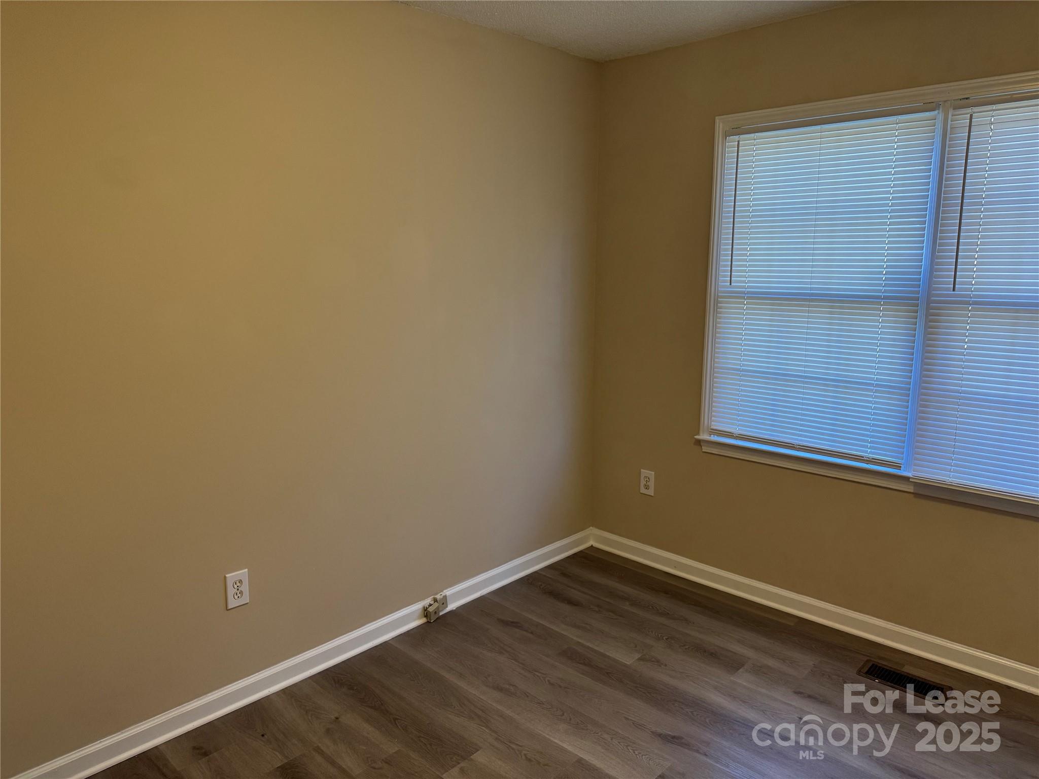 1424 Ridgewood Drive Concord, NC 28027 - Photo 14 of 14 a view of a room with wooden floor and cabinet