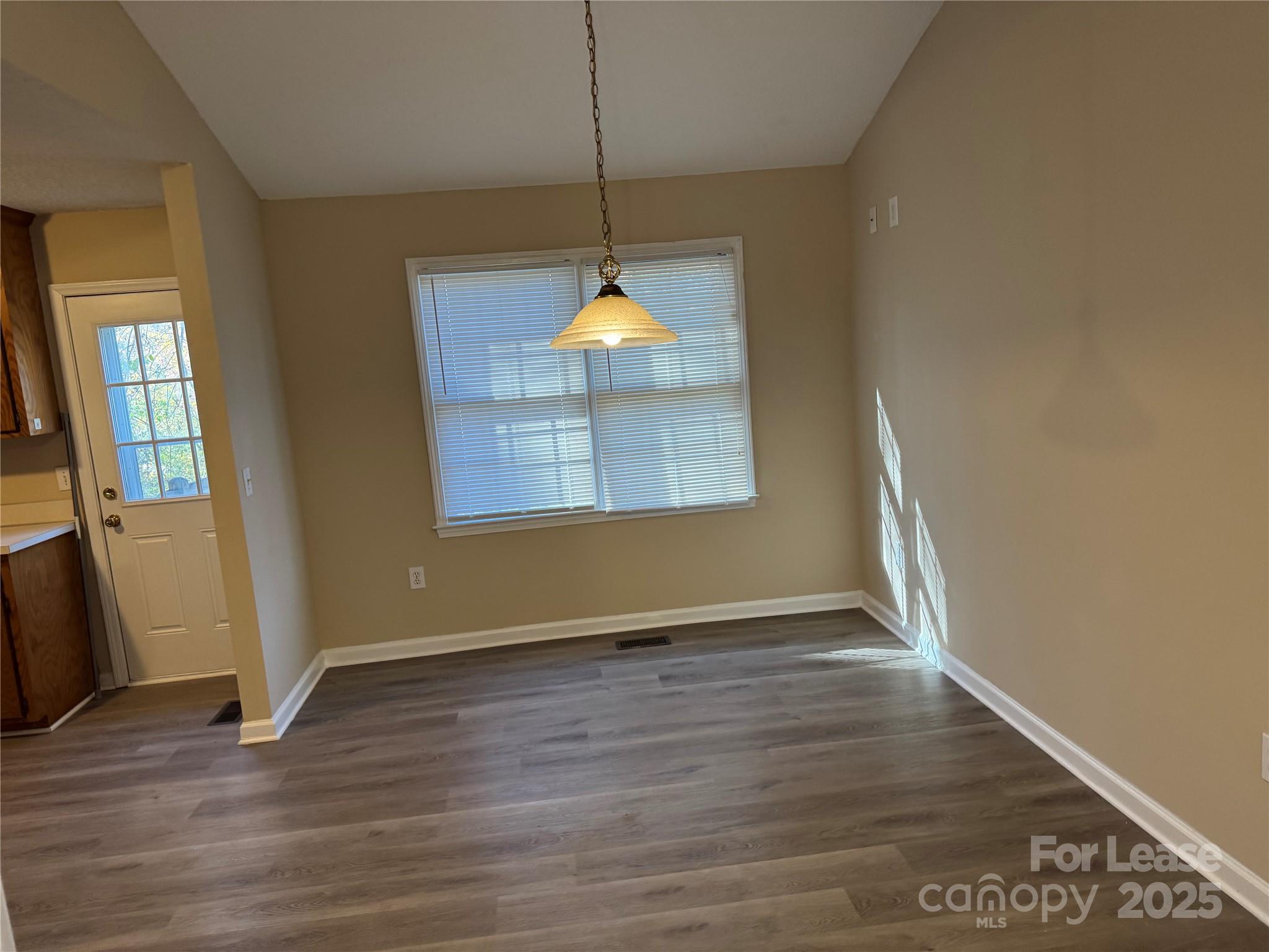 1424 Ridgewood Drive Concord, NC 28027 - Photo 2 of 14 an empty room with wooden floor and windows
