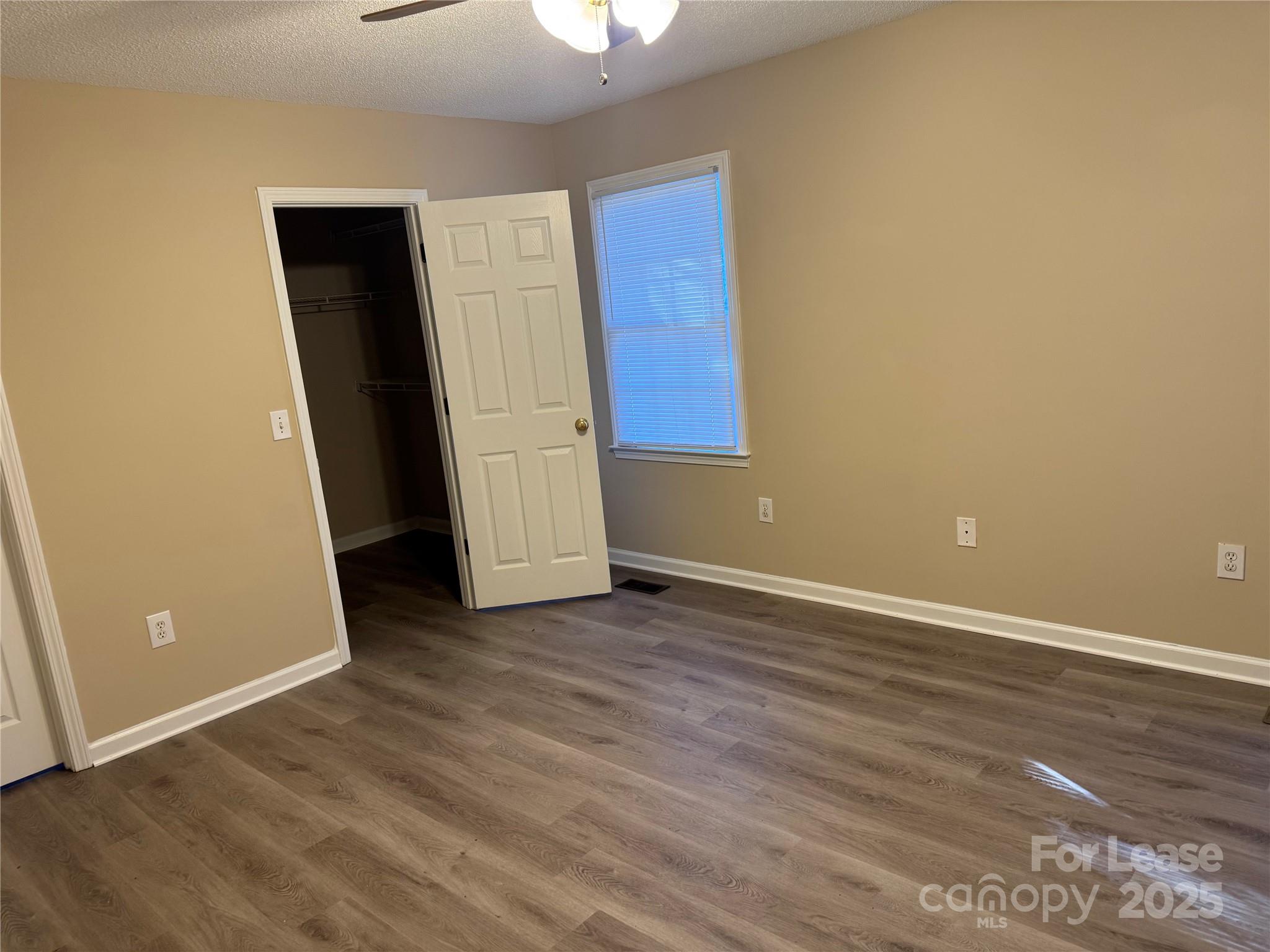 1424 Ridgewood Drive Concord, NC 28027 - Photo 10 of 14 an empty room with wooden floor and closet