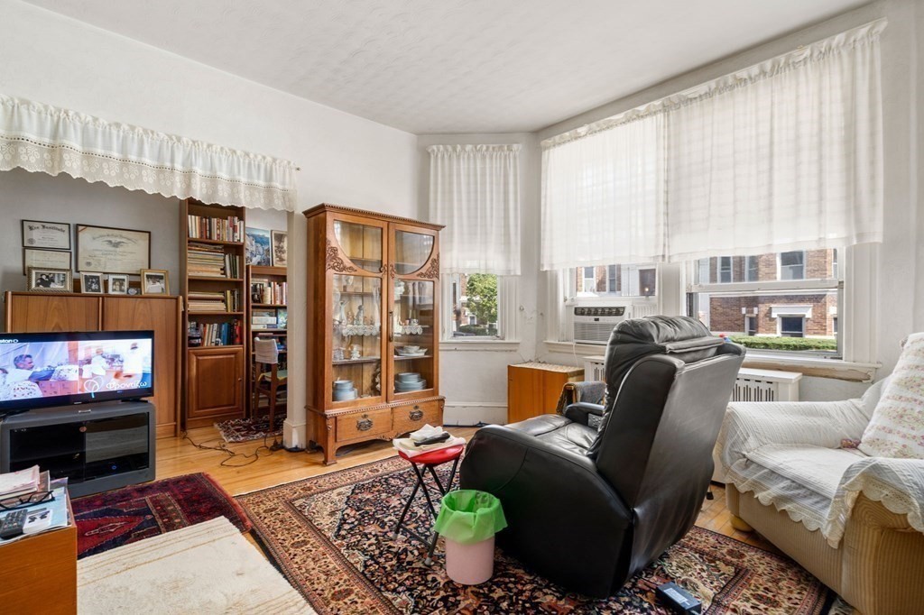6 Colborne Road, Unit 1 Boston, MA 02135 - Photo 2 of 11 a living room with furniture and a flat screen tv