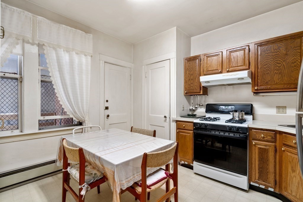 6 Colborne Road, Unit 1 Boston, MA 02135 - Photo 4 of 11 a kitchen with a stove a sink and a refrigerator