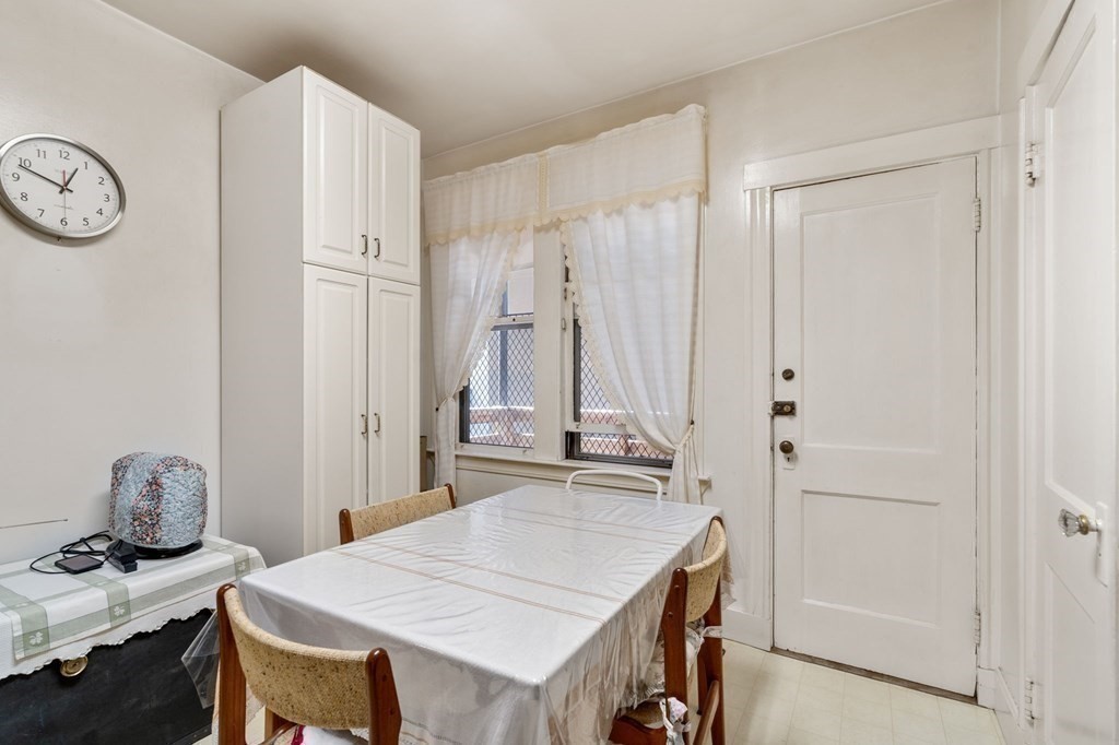 6 Colborne Road, Unit 1 Boston, MA 02135 - Photo 5 of 11 a kitchen with a table chairs and a refrigerator