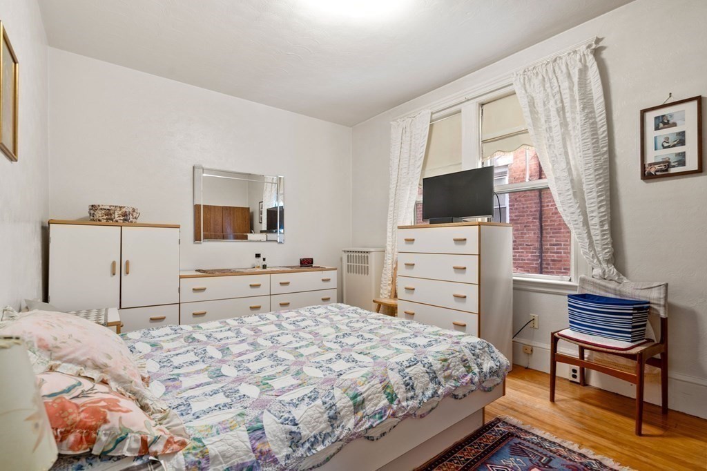 6 Colborne Road, Unit 1 Boston, MA 02135 - Photo 6 of 11 a bedroom with a bed and a flat screen tv in it