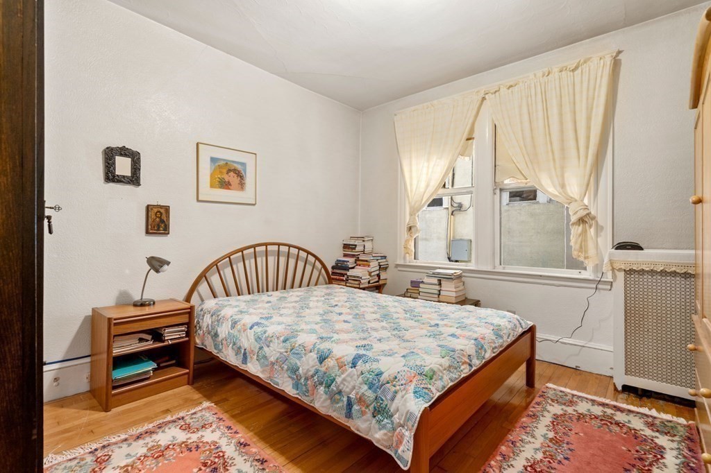6 Colborne Road, Unit 1 Boston, MA 02135 - Photo 7 of 11 a bedroom with a bed and a window