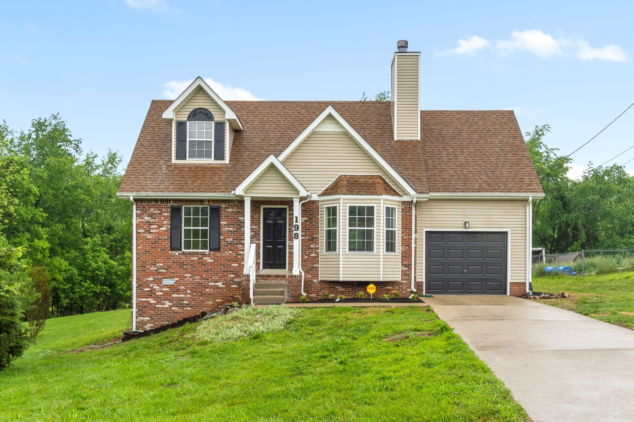 a front view of a house with a yard and garage
