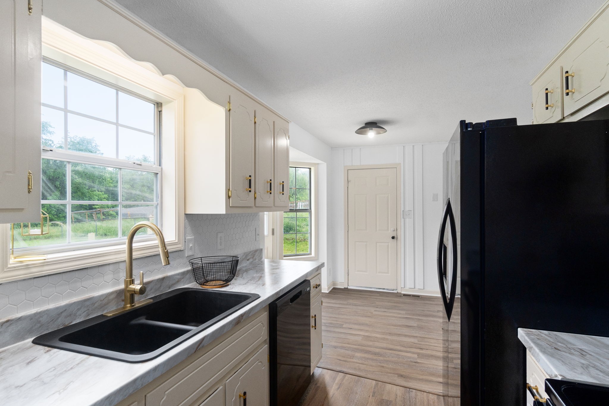 198 Cummings Creek Road Clarksville, TN 37042 - Photo 17 of 43 a kitchen with a sink a refrigerator and window