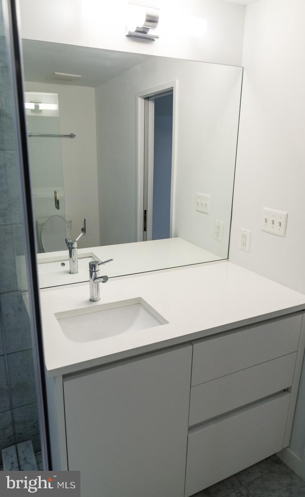 1443 Euclid Street Northwest, Unit 1 Washington, DC 20009 - Photo 13 of 14 a bathroom with a sink and a mirror