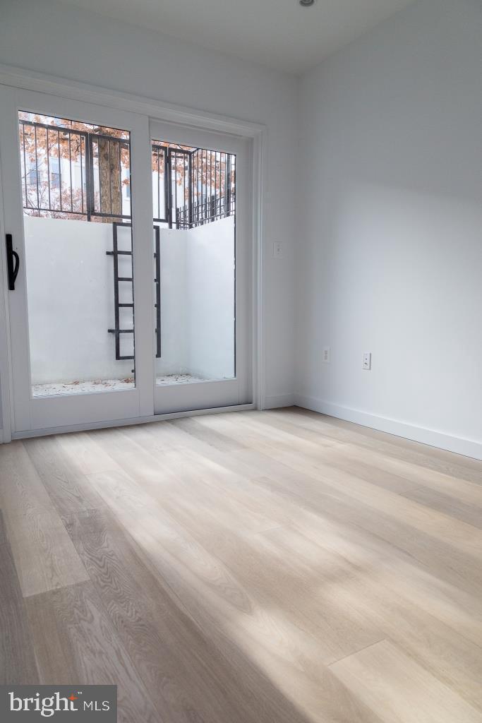 1443 Euclid Street Northwest, Unit 1 Washington, DC 20009 - Photo 6 of 14 an empty room with windows