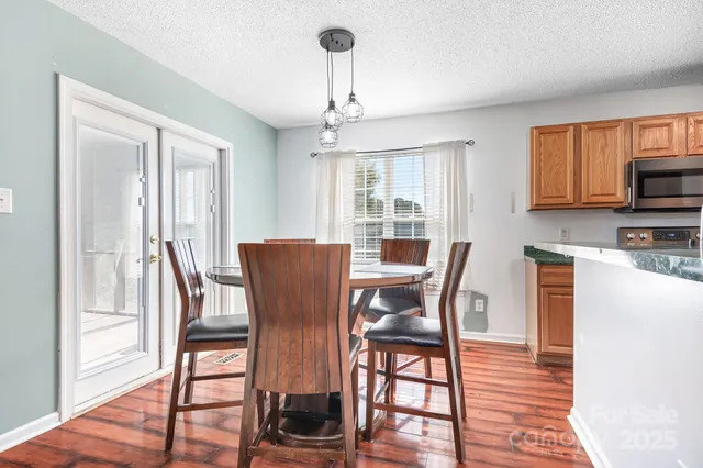 a view of a dining room with furniture window and wooden floor