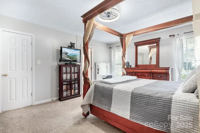 a bedroom with a large bed and a window