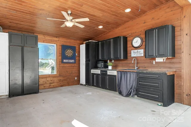 a view of kitchen with cabinets and window