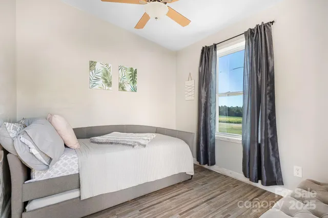 a bed sitting in a bedroom next to a window